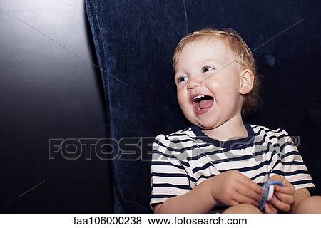 Stock Photo - Toddler laughing, portrait. Fotosearch