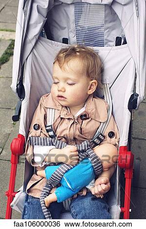Toddler sleeping in stroller View Large Photo Image Stock Photograph - Toddler sleeping in stroller. Fotosearch