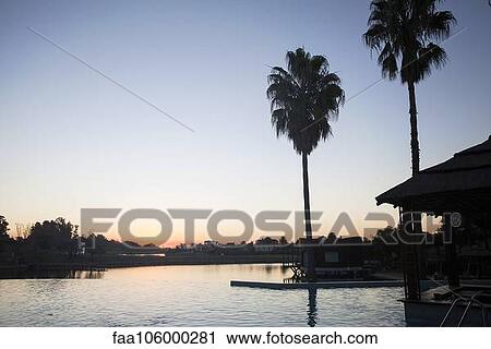 Tranquil sunset over lake View Large Photo Image Stock Image - Tranquil sunset over lake. Fotosearch