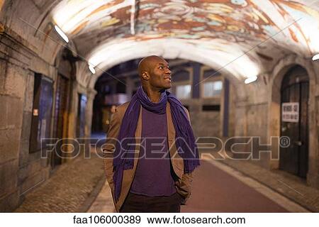Stock Photo - Traveler admiring graffiti on ceiling. Fotosearch
