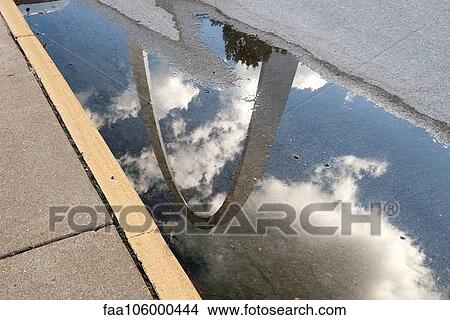 Picture - USA, Missouri, St. Louis, Gateway Arch reflected in a puddle. Fotosearch