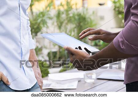 Stock Image - Using digital tablet. Fotosearch