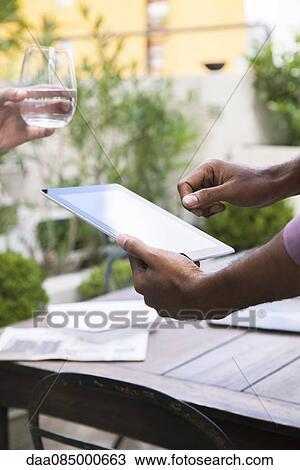 Stock Image - Using digital tablet. Fotosearch