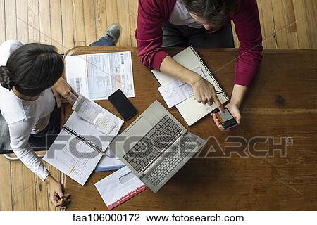 Using smartphone and laptop to manage home finances View Large Photo Image Stock Image - Using smartphone and laptop to manage home finances. Fotosearch