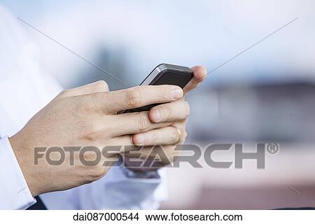 Using smartphone, close-up View Large Photo Image Picture - Using smartphone, close-up. Fotosearch