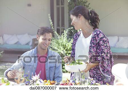 Wife serving salad to husband View Large Photo Image Stock Photo - Wife serving salad to husband. Fotosearch