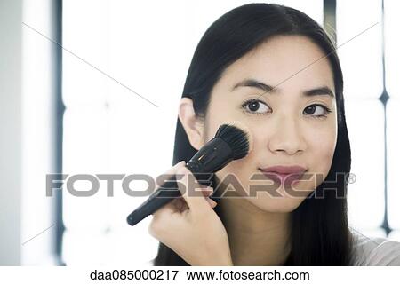 Woman applying blush View Large Photo Image Stock Photo - Woman applying blush. Fotosearch