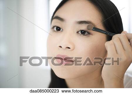 Woman applying eye shadow View Large Photo Image Stock Image - Woman applying eye shadow. Fotosearch