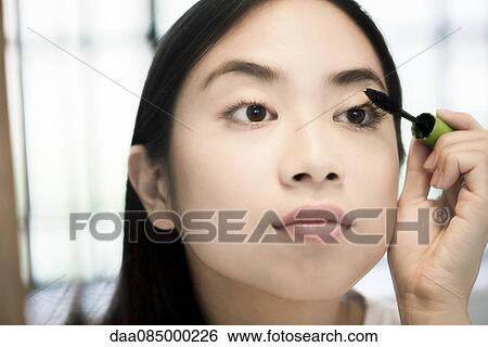 Woman applying mascara View Large Photo Image Stock Photograph - Woman applying mascara. Fotosearch