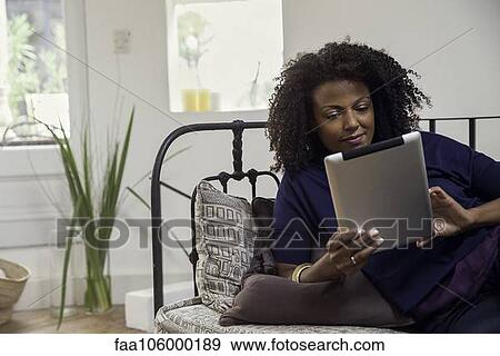 Woman checking e-mail with digital tablet View Large Photo Image Stock Photo - Woman checking e-mail with digital tablet. Fotosearch