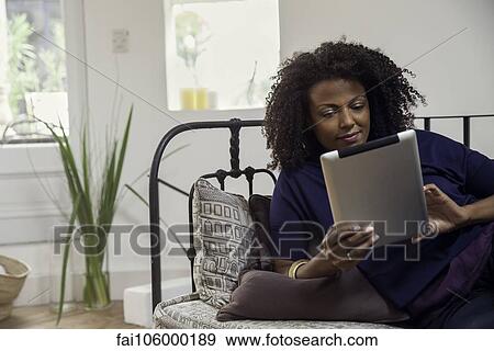 Woman checking e-mail with digital tablet View Large Photo Image Stock Photo - Woman checking e-mail with digital tablet. Fotosearch