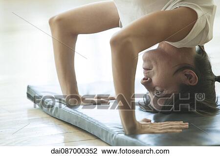 Woman doing a headstand, close-up View Large Photo Image Stock Image - Woman doing a headstand, close-up. Fotosearch