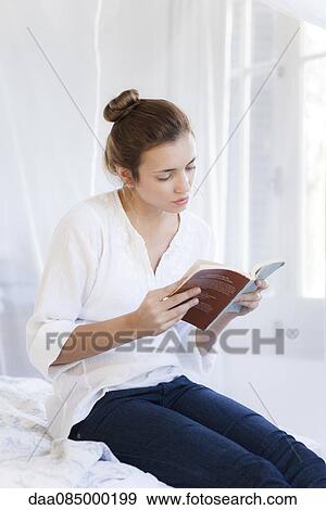 Woman engrossed in novel View Large Photo Image Stock Photo - Woman engrossed in novel. Fotosearch
