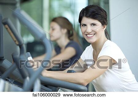 Woman exercising in fitness club View Large Photo Image Stock Photo - Woman exercising in fitness club. Fotosearch