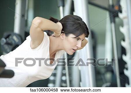 Woman exercising in health club View Large Photo Image Stock Photo - Woman exercising in health club. Fotosearch
