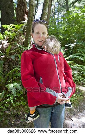 Stock Photograph - Woman hiking outdoors with young child. Fotosearch