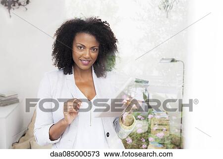 Woman holding digital tablet View Large Photo Image Stock Image - Woman holding digital tablet. Fotosearch