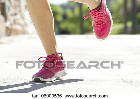Woman jogging in sports shoes, cropped View Large Photo Image Stock Photograph - Woman jogging in sports shoes, cropped. Fotosearch