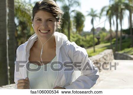 Woman jogging, smiling cheerfully, portrait View Large Photo Image Picture - Woman jogging, smiling cheerfully, portrait. Fotosearch