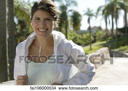 Woman jogging, smiling cheerfully, portrait View Large Photo Image Picture - Woman jogging, smiling cheerfully, portrait. Fotosearch