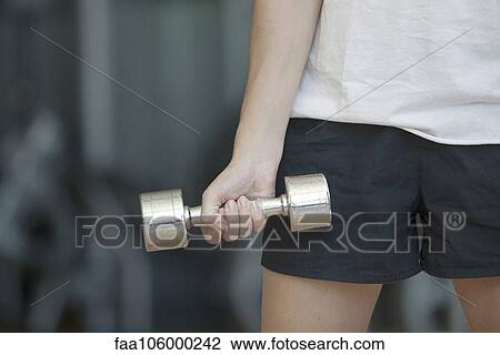 Woman lifting dumbbell, cropped View Large Photo Image Stock Image - Woman lifting dumbbell, cropped. Fotosearch
