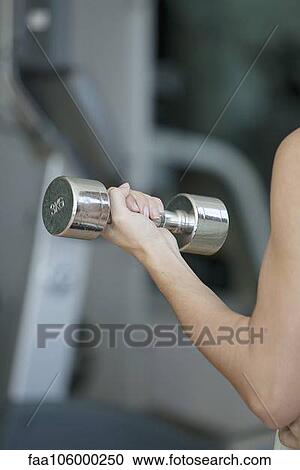 Woman lifting dumbbell, cropped View Large Photo Image Stock Image - Woman lifting dumbbell, cropped. Fotosearch