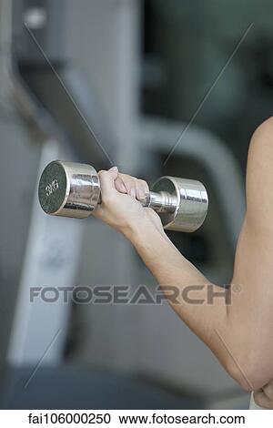 Woman lifting dumbbell, cropped View Large Photo Image Stock Image - Woman lifting dumbbell, cropped. Fotosearch