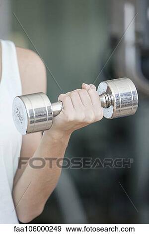 Woman lifting dumbbell, cropped View Large Photo Image Stock Photo - Woman lifting dumbbell, cropped. Fotosearch