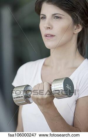Woman lifting dumbbell View Large Photo Image Stock Photo - Woman lifting dumbbell. Fotosearch