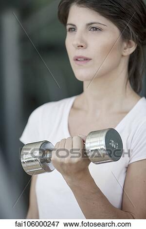 Woman lifting dumbbell View Large Photo Image Stock Photo - Woman lifting dumbbell. Fotosearch