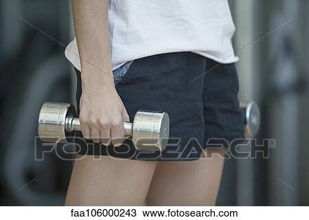 Woman lifting dumbbells, cropped View Large Photo Image Stock Image - Woman lifting dumbbells, cropped. Fotosearch