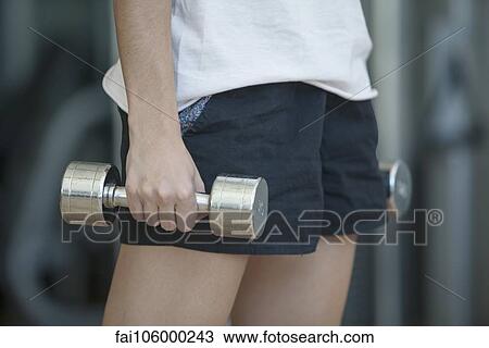 Woman lifting dumbbells, cropped View Large Photo Image Stock Image - Woman lifting dumbbells, cropped. Fotosearch