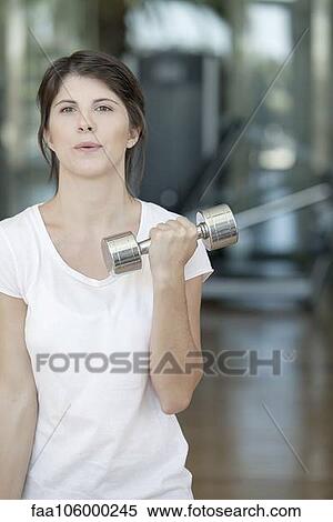 Woman lifting weights View Large Photo Image Stock Photography - Woman lifting weights. Fotosearch
