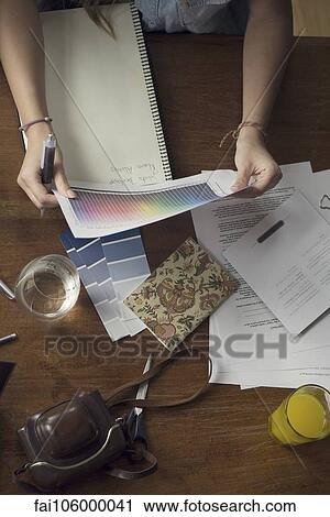 Woman looking at color spectrum sheet View Large Photo Image Stock Image - Woman looking at color spectrum sheet. Fotosearch