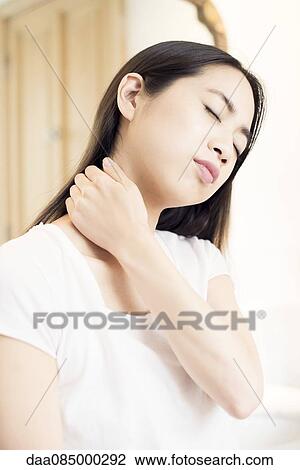 Woman massaging her neck View Large Photo Image Stock Image - Woman massaging her neck. Fotosearch
