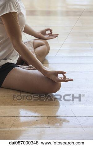 Woman meditating in lotus position, cropped View Large Photo Image Stock Photo - Woman meditating in lotus position, cropped. Fotosearch