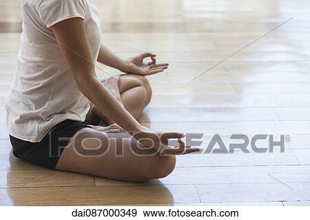 Woman meditating in lotus position, cropped View Large Photo Image Stock Photo - Woman meditating in lotus position, cropped. Fotosearch