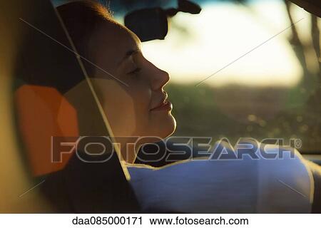 Stock Image - Woman passenger riding in car. Fotosearch