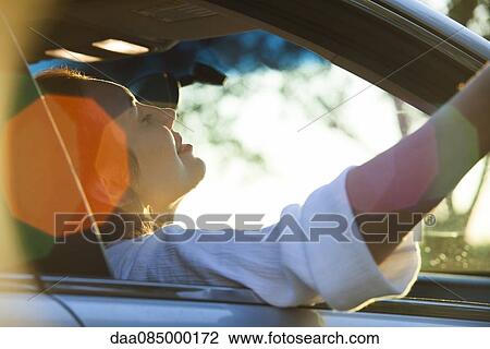 Woman passenger riding in car View Large Photo Image Stock Image - Woman passenger riding in car. Fotosearch