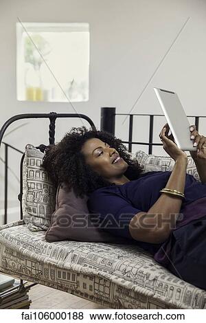 Woman reading e-book on digital tablet View Large Photo Image Stock Photo - Woman reading e-book on digital tablet. Fotosearch