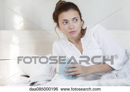 Woman reading in bed View Large Photo Image Stock Photograph - Woman reading in bed. Fotosearch