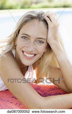 Woman relaxing at poolside, portrait View Large Photo Image Stock Image - Woman relaxing at poolside, portrait. Fotosearch