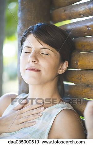 Woman relaxing with eyes closed View Large Photo Image Stock Photo - Woman relaxing with eyes closed. Fotosearch