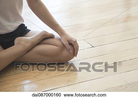 Woman seated in lotus position, cropped View Large Photo Image Stock Image - Woman seated in lotus position, cropped. Fotosearch