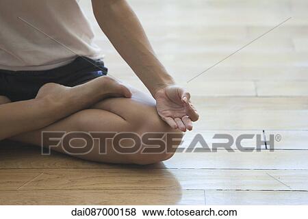 Woman seated in lotus position, cropped View Large Photo Image Stock Photo - Woman seated in lotus position, cropped. Fotosearch