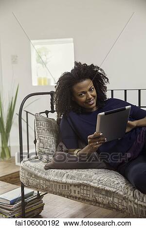 Stock Image - Woman shopping online using digital tablet. Fotosearch