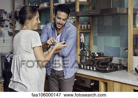 Woman showing husband smartphone View Large Photo Image Stock Photo - Woman showing husband smartphone. Fotosearch