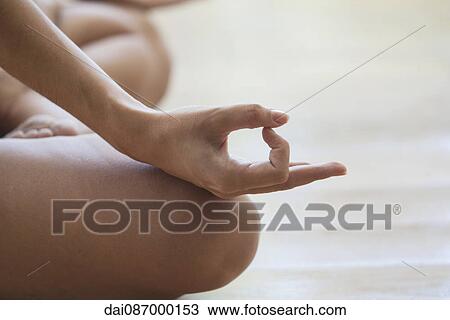 Woman sitting in lotus position, cropped View Large Photo Image Stock Image - Woman sitting in lotus position, cropped. Fotosearch