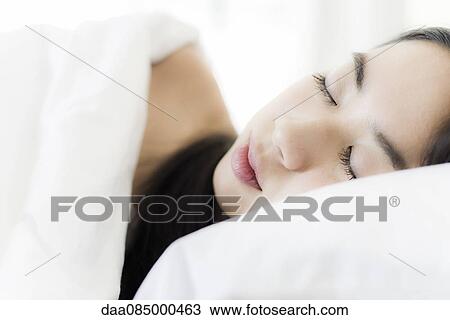 Stock Image - Woman sleeping in bed, close-up. Fotosearch