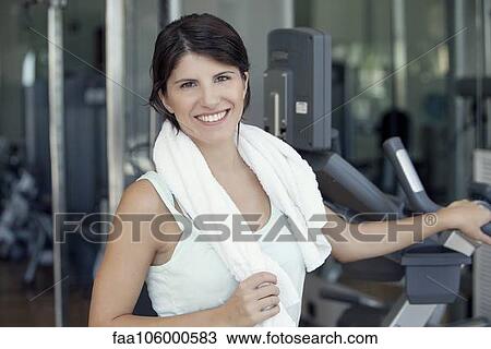 Woman smiling after workout in fitness club, portrait View Large Photo Image Stock Image - Woman smiling after workout in fitness club, portrait. Fotosearch